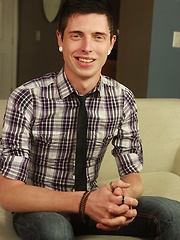 Tattooed Ray Ryder masturbating on the sofa.